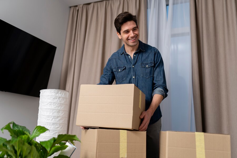 man-handling-belongings-after-moving-new-home_23-2149312699