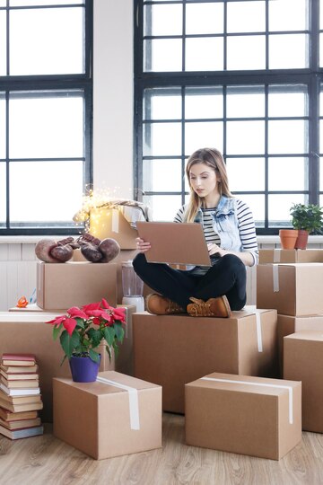 woman-finished-with-cargo-packages-is-calling-courrier-shipping-via-computer_144627-33485