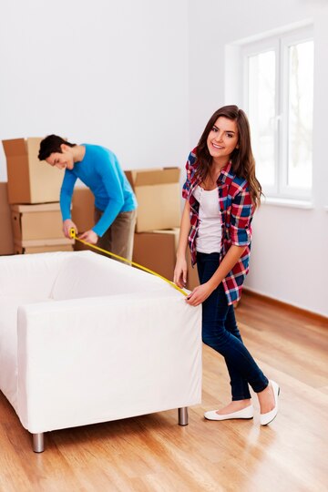 young-couple-measuring-sofa-their-new-apartment_329181-12581