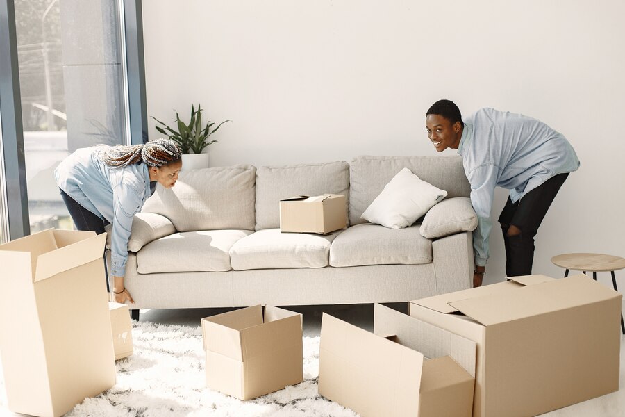 young-couple-moving-new-home-together-african-american-couple-with-cardboard-boxes_1157-40330